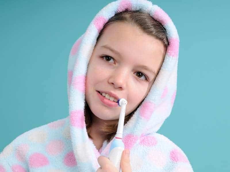 Young Girl With Electric Toothbrush