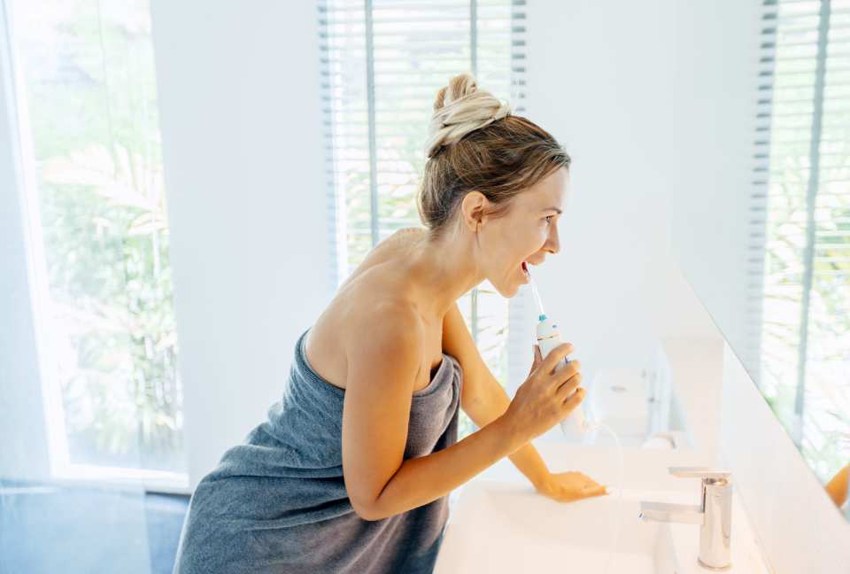 Woman using a water flosser