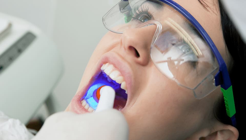 A close up of a female having a filling at the dentists
