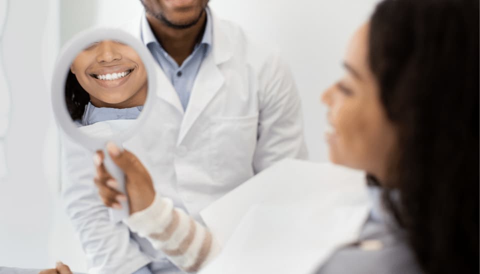 Woman admiring her teeth after cosmetic dentistry