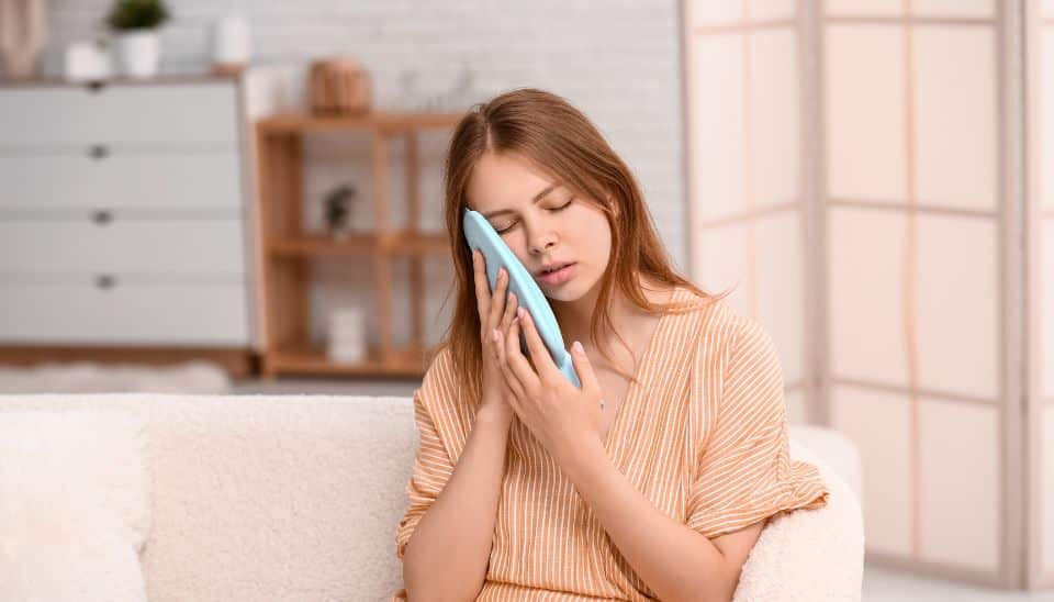 Female using Cold Compress on dental pain