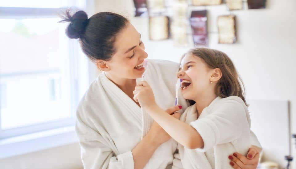 Family brushing teeth together