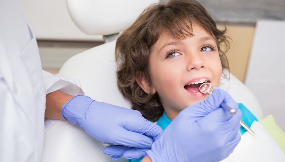 Kid visiting dentist during school holidays